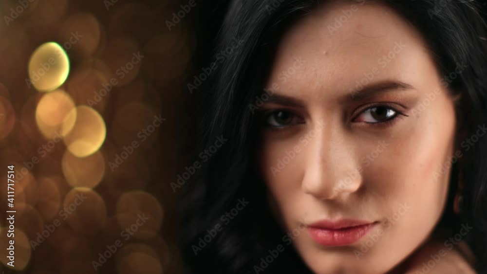 Face of Asian woman jewelry earrings posing at black golden bokeh. Close up shot on 4k RED camera Face of Asian woman jewelry earrings posing at black golden bokeh. Close up shot on 4k RED camera