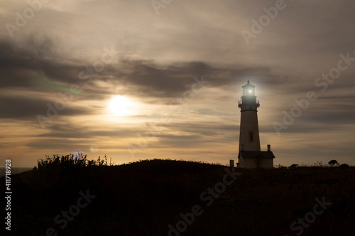 Yaquina Head Lighthouse built in 1873, with golden sunset - Oregon, USA