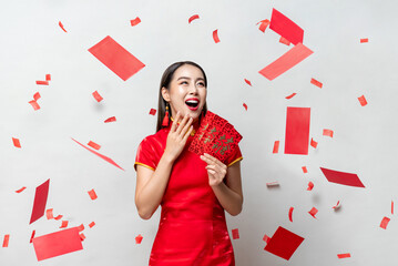 Surprised Asian woman in traditional costume with red envelopes 