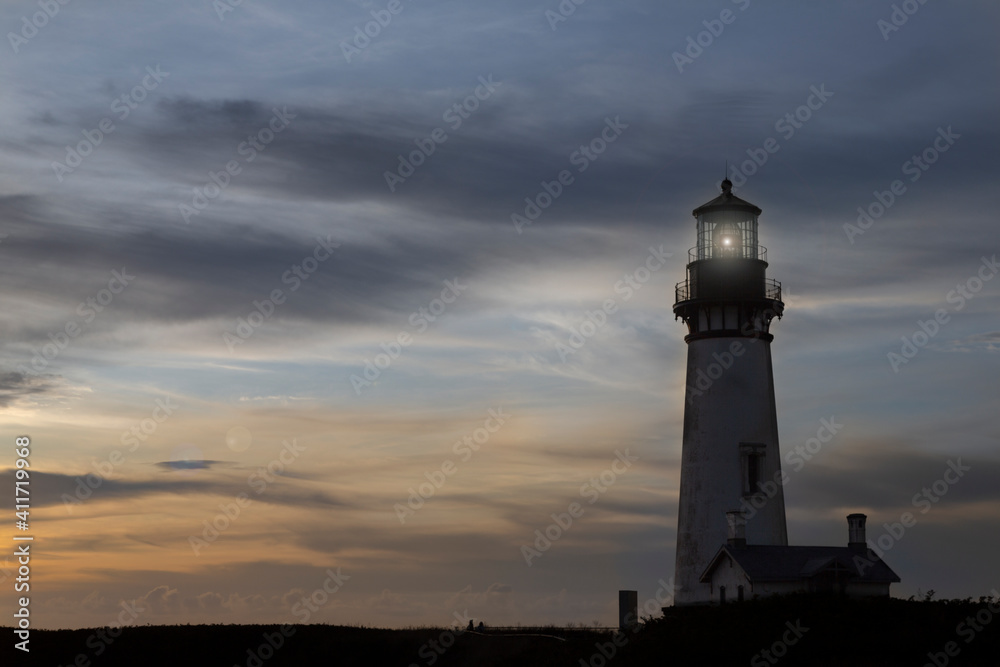 Yaquina Head Lighthouse built in 1873, with colorful sunset - Oregon, USA, 