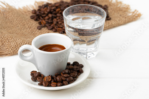 Fototapeta Naklejka Na Ścianę i Meble -  Cup of espresso with glass of water on white table