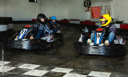 active positive people driving sport cars for karting in a circuit lap in sport club