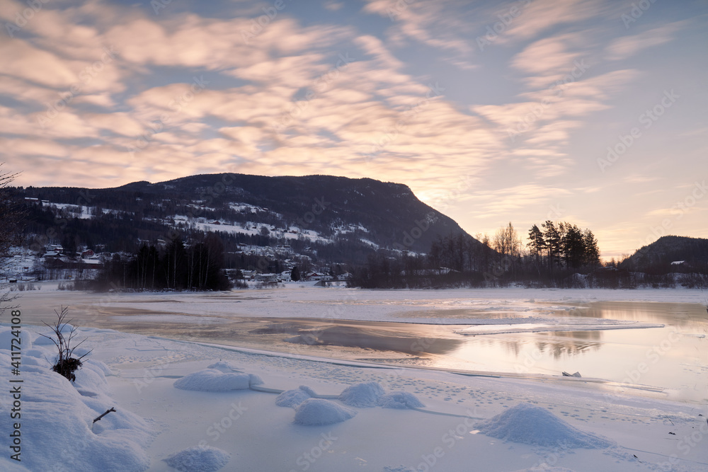 Winter theme at Hallingdalselva. A beautiful river in Hallingdal, Gol is freezing up in the cold February morning. Winter theme at Hallingdalselva. A beautiful river in Hallingdal, Gol is freezing up in the cold February morning.