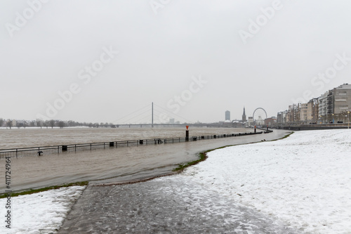 High water after heavy rainfall and snow melting in February drowned the flooded coast as weather catastrophe in Düsseldorf shows extreme weather, high tide and insurance risks at the coast with flood © sunakri