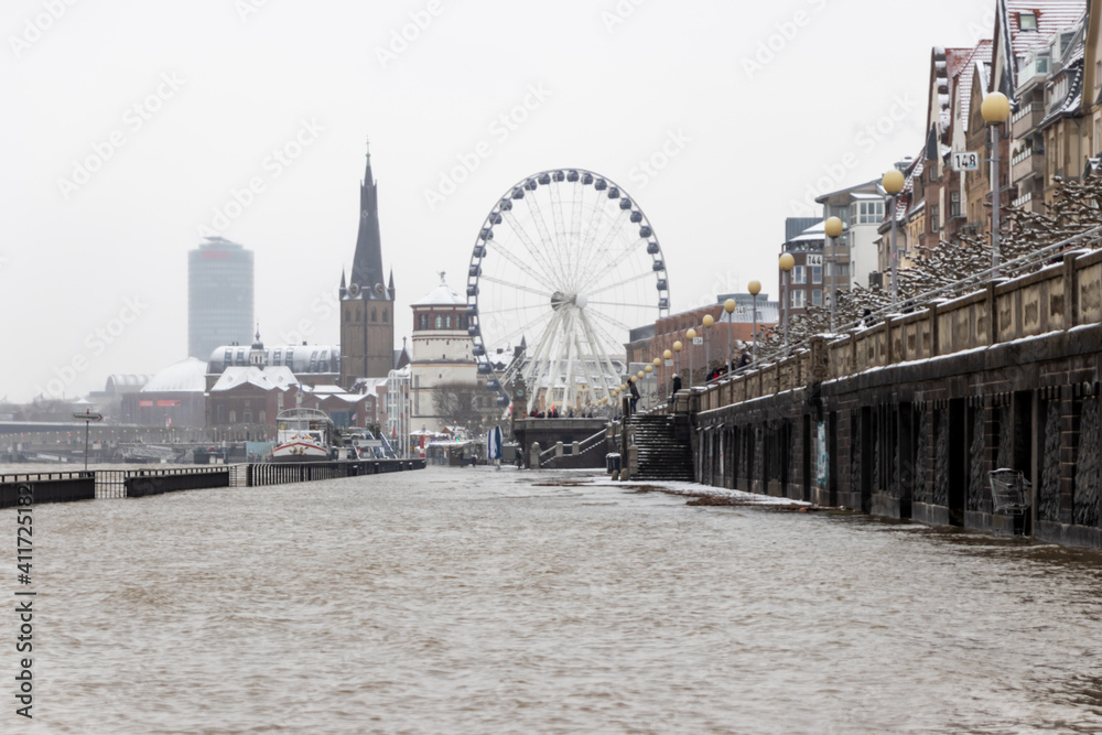 High water after heavy rainfall and snow melting in February drowned the flooded coast as weather catastrophe in Düsseldorf shows extreme weather, high tide and insurance risks at the coast with flood