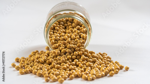 Closeup of dried soybeans on the table and in glass on white background, healthy food