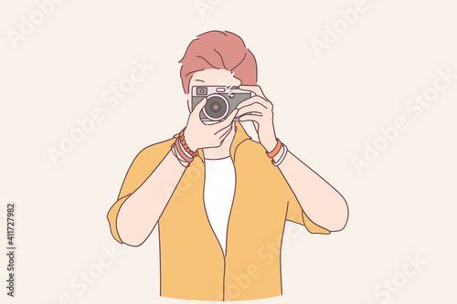 Creativity, photograph, artist concept. Young man freelancer photographer cartoon character standing making shot to camera vector illustration 