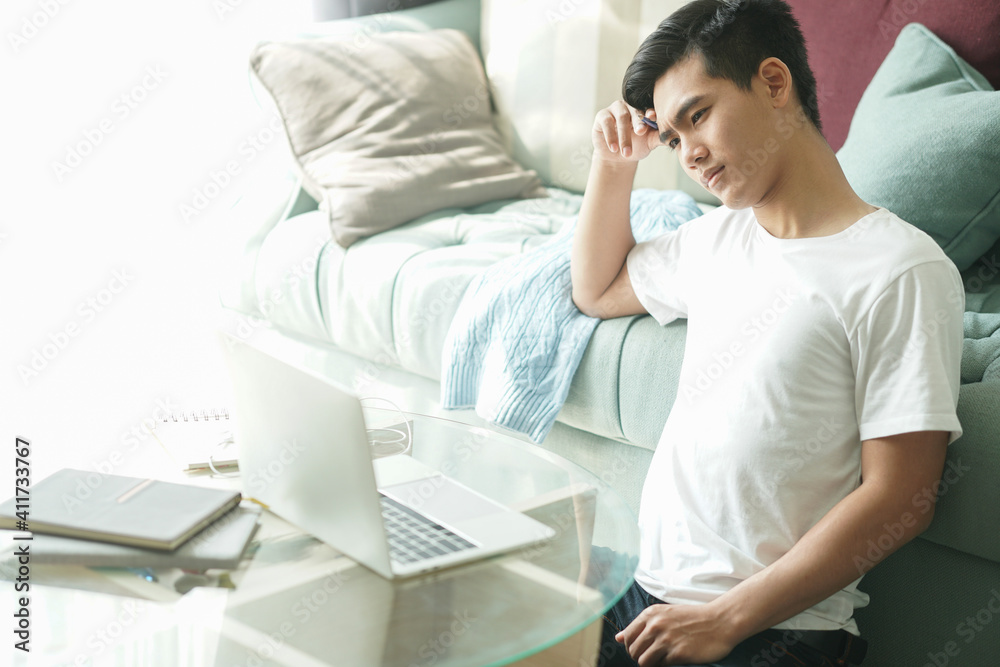 tired exhausted frustrated asian student man teenager entrepreneur working at home