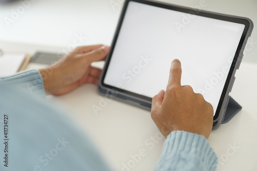 hand touching white blank screen of digital tablet