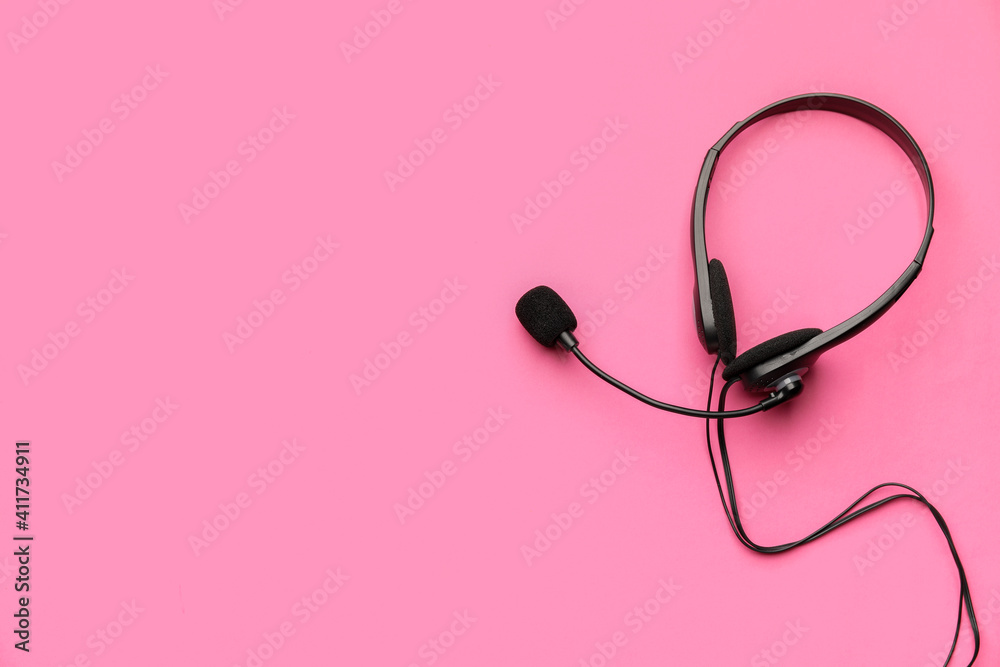 Headphones with microphone on color background Headphones with microphone on color background