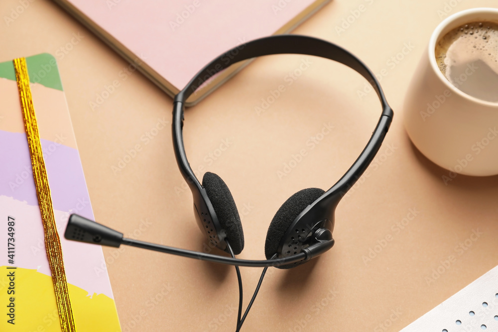 Headset with notebooks on color background Headset with notebooks on color background