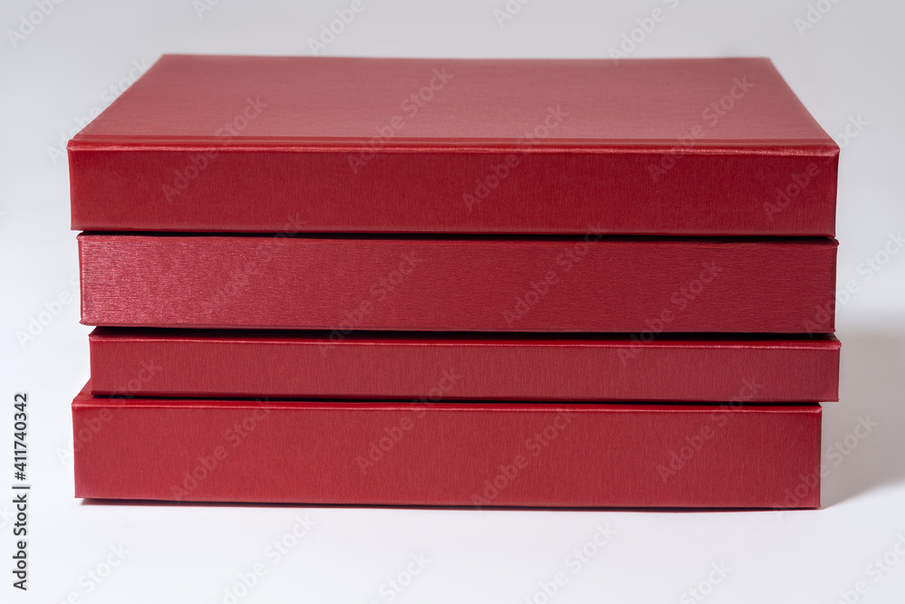Stack of red hardcover books or reports on white background. Copy space. Stack of red hardcover books or reports on white background. Copy space.