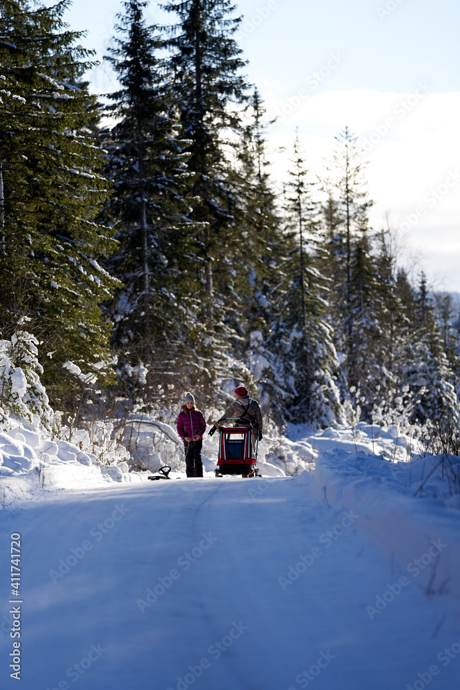 Mother and daughter walking on a winter road. Cold but sun. Shot in Gol, Hallingdal.
