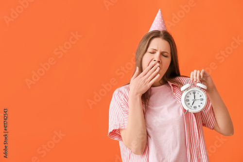 Tired woman with alarm cloc...