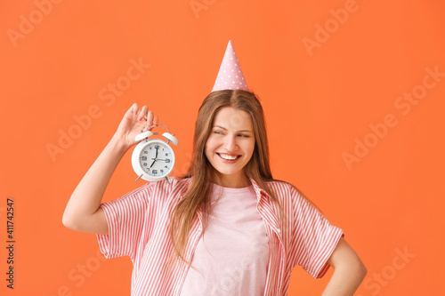 Happy woman with alarm cloc...
