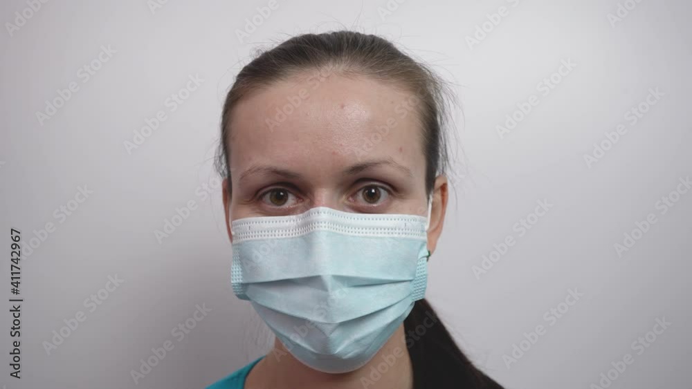Portrait of a girl in a medical mask. Girl winks