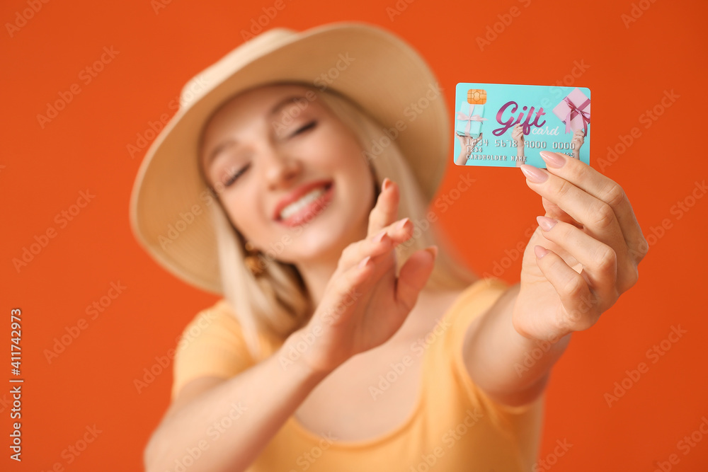 Beautiful young woman with gift card on color background Beautiful young woman with gift card on color background