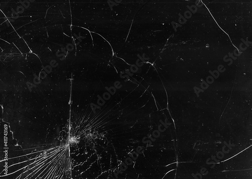 Shattered background. Smashed glass texture. Black distressed cracked old screen with dust scratches dirt stains abstract poster.