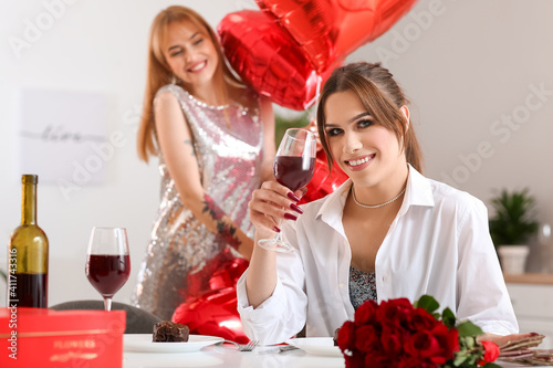 Smiling young woman toastin...