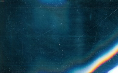 Dust scratches overlay. Old film effect. Blue distressed faded glass with smeared dirt stains colorful rainbow lens flare design.