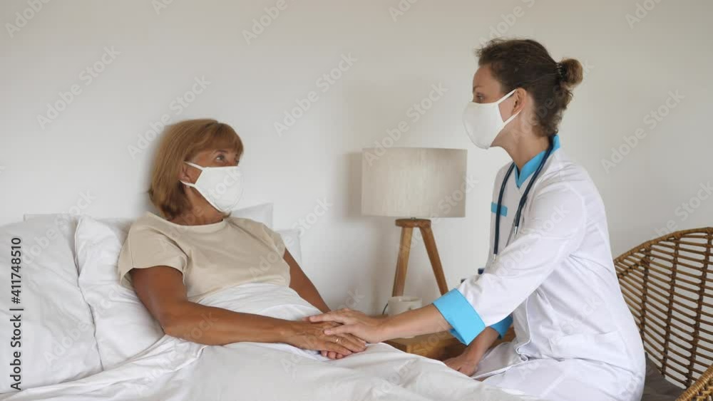 Private doctor visiting middle aged patient at home, treats and comforts her Private doctor visiting middle aged patient at home, treats and comforts her