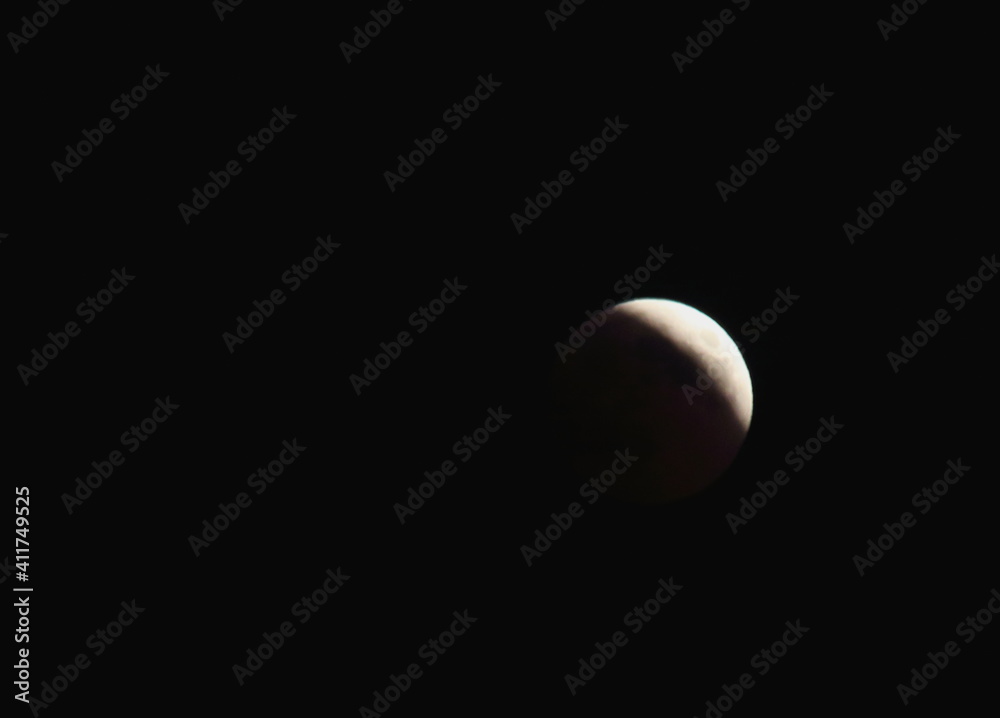 evocative image of moon eclipse at night up in the sky
evocative image of moon eclipse at night up in the sky
