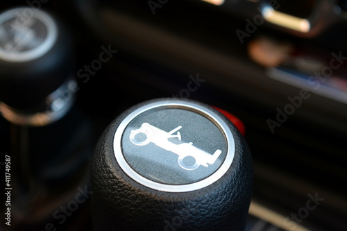 close up of a gear knob of an all wheel drive vehicle with a suv symbol