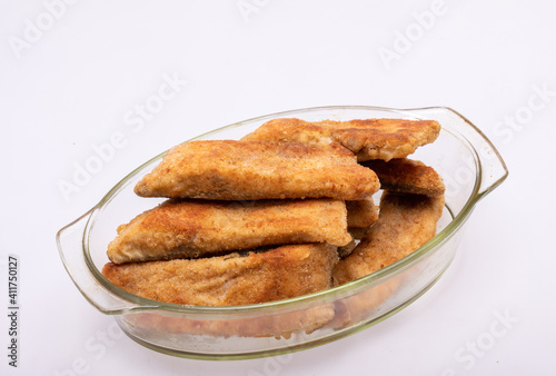 Breaded fish fillets in a glass, heat-resistant dish