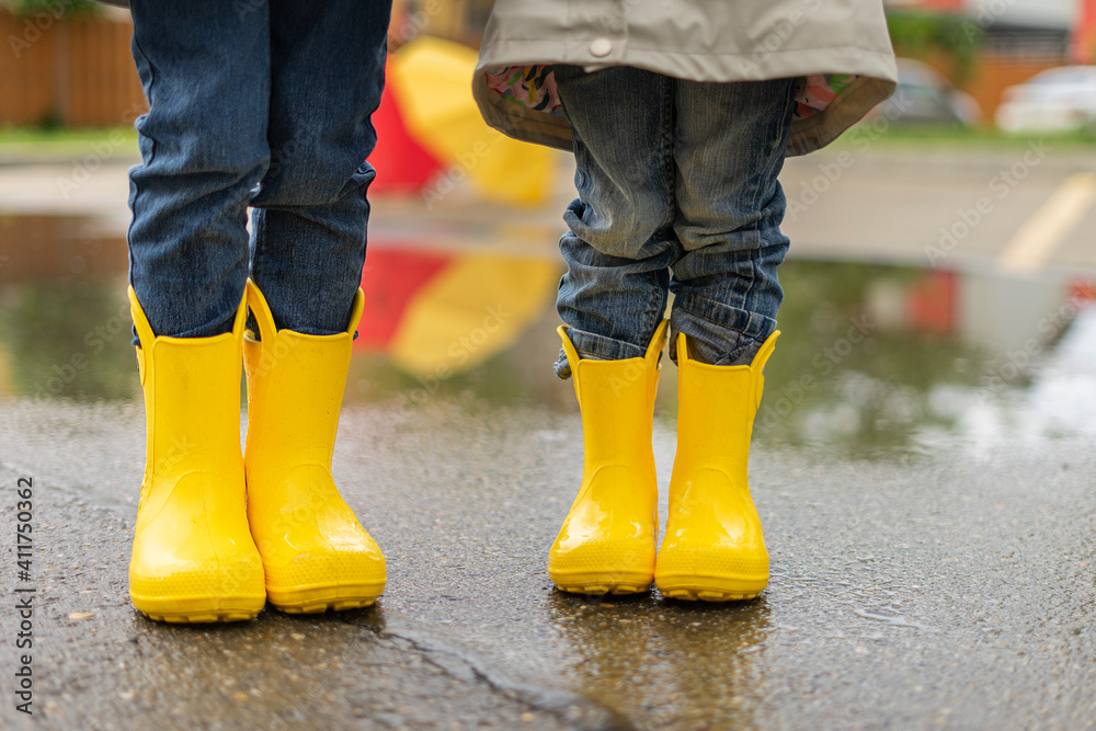 child jumps in a puddle. Legs 