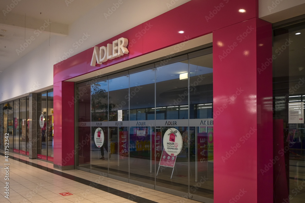 Luebeck, Germany, January 25, 2021: Closed entrance front of the insolvent  clothing store chain Adler during the lockdown in the coronavirus pandemic,  фотография Stock | Adobe Stock
