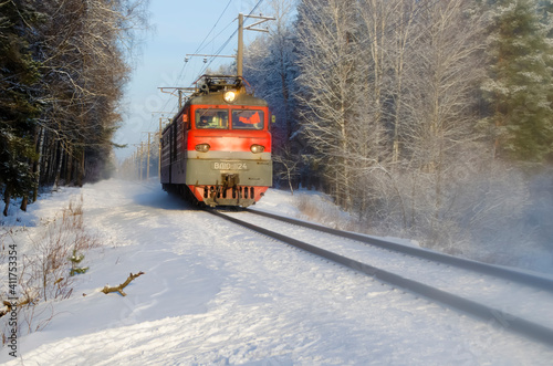 Moving train in the winter forest