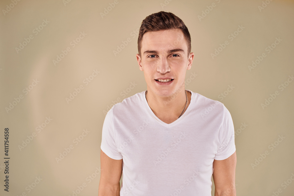 Obraz premium Cute emotional man white t-shirt gesture with hands cropped view beige studio background