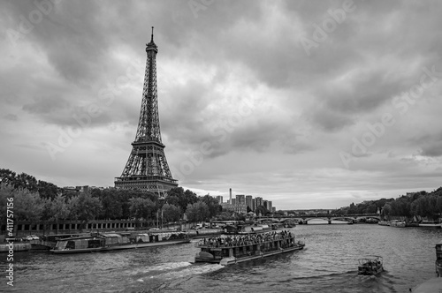 Paris, France - July 18, 2019: Black and white photograph of tourist boats navigating the River Seine and Eiffel Tower in Paris, France © Arty Om