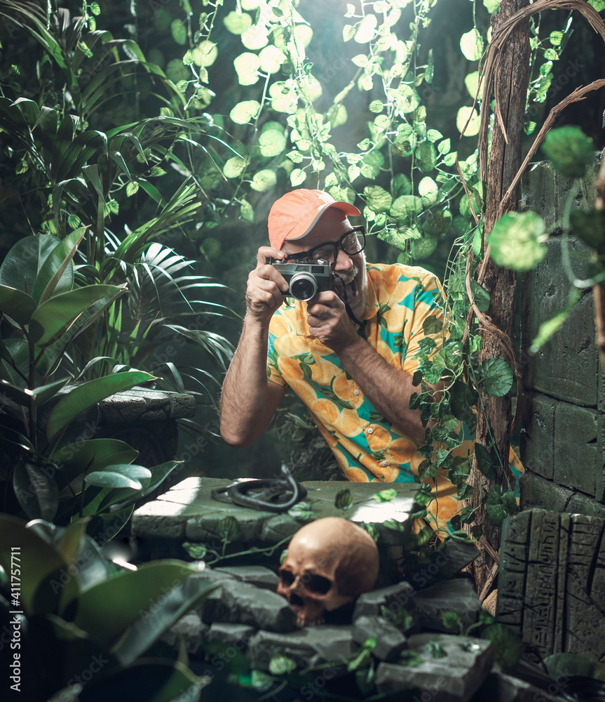 Funny cheerful tourist taking pictures in the jungle