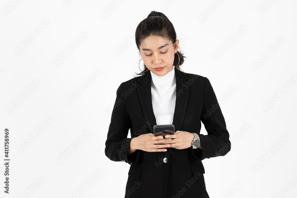 Young Asian business woman in suit holding mobile smart phone over white isolated background. Young Asian business woman in suit holding mobile smart phone over white isolated background.