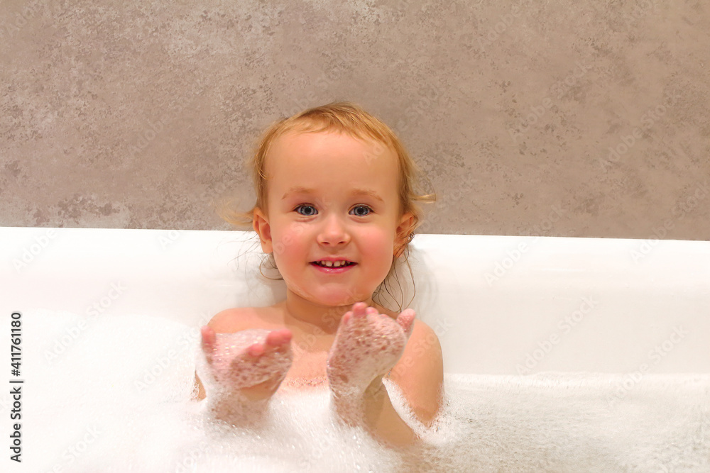 Little baby bathing in bathtub. Child washing in soapy water with foam. Little baby bathing in bathtub. Child washing in soapy water with foam.