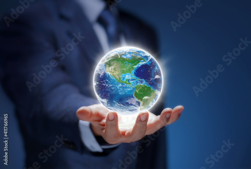 Earth in hand of business man show USA world map. Businessman hold Global world for communicate  environment  save earth  worldwide  network  concept. Elements of this image are furnished by NASA