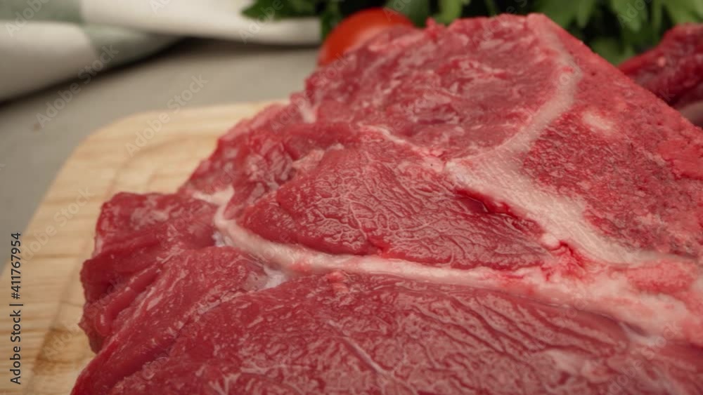 Raw beef steak with spice and seasoning close up Raw beef steak with spice and seasoning close up