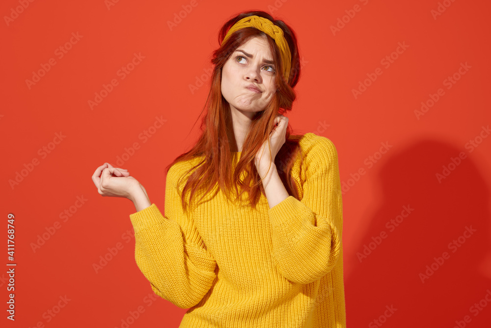 pretty emotional woman holding her hair Yellow sweater fashion red background pretty emotional woman holding her hair Yellow sweater fashion red background