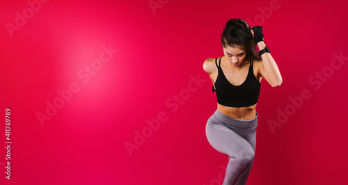 Banner, long format. Motivated girl run on a red background with side space. Athletic physique. Healthy lifestyle concept.