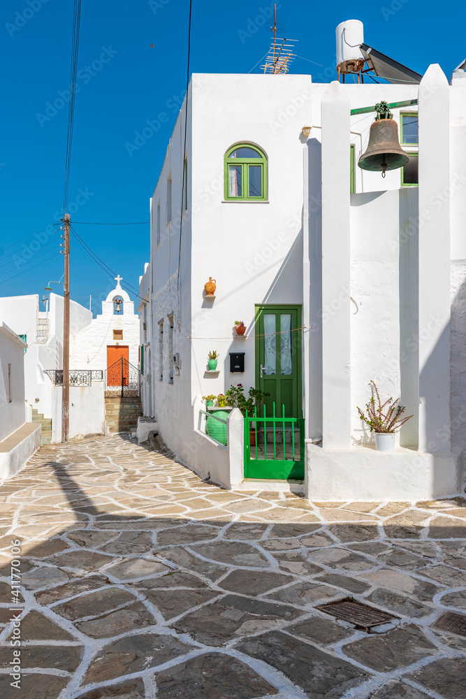 Fototapeta premium Traditional alley with whitewashed houses during winter time in lefkes Paros island