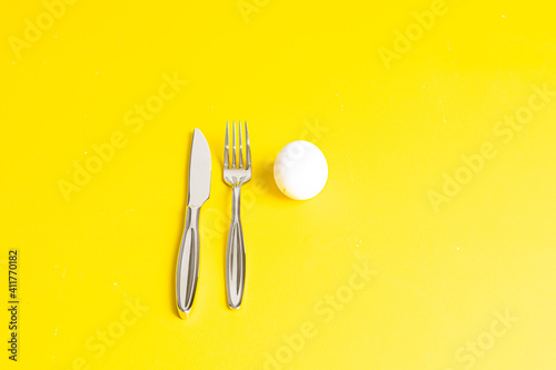 Cracked chicken egg with yolk and eggshell. Minimal Easter holiday concept Egg shell and egg yolk Creative copy space on a yellow background © Владислав Легір