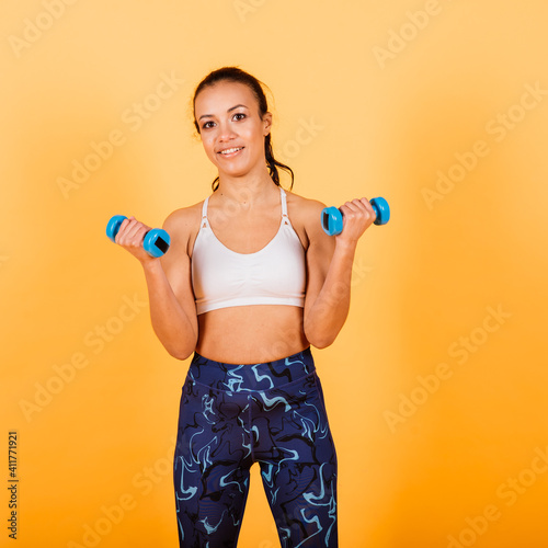 Strength and motivation. Full length of young and slim african woman in sports clothing exercising