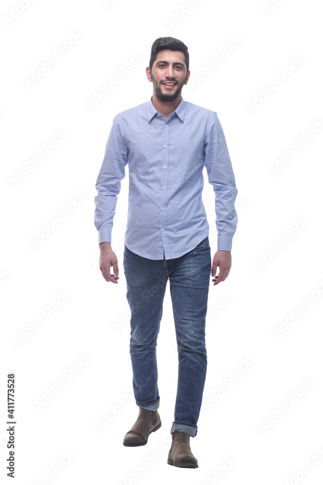 confident young man in jeans striding forward. confident young man in jeans striding forward.