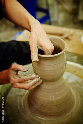 working with clay on potter's wheel