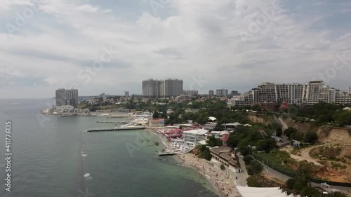 shooting from a quadcopter view of the beach and the city by the sea
