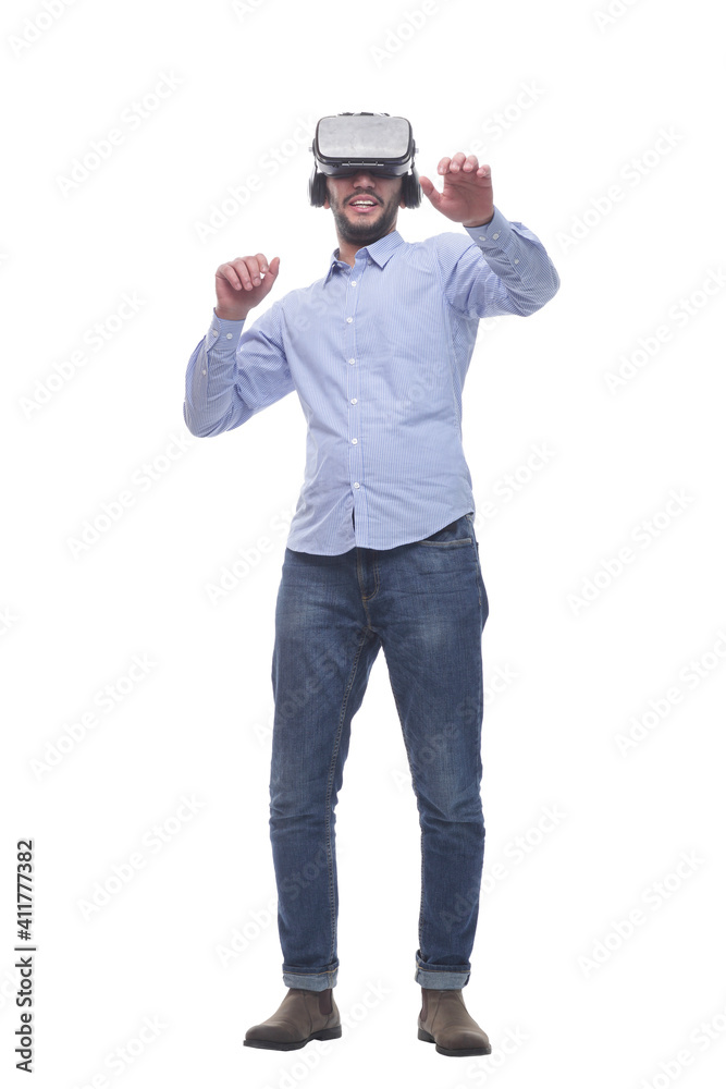 in full growth. smiling young man wearing virtual reality glasses. in full growth. smiling young man wearing virtual reality glasses.