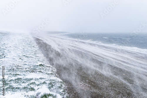 White-out blizzard snow storm on a sea dike in Den Helder, Holland, Netherlands photo