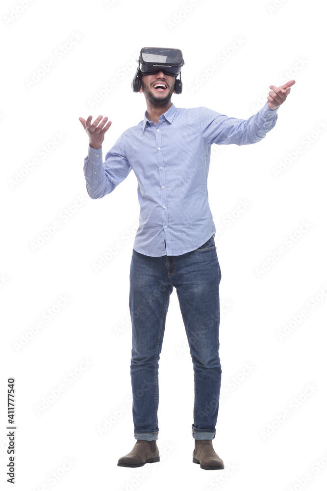 in full growth. smiling young man wearing virtual reality glasses. in full growth. smiling young man wearing virtual reality glasses.