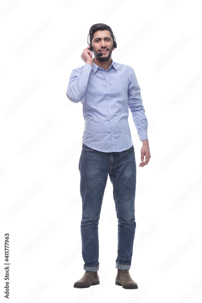 Fototapeta premium in full growth. young man in a headset looking at a white screen.